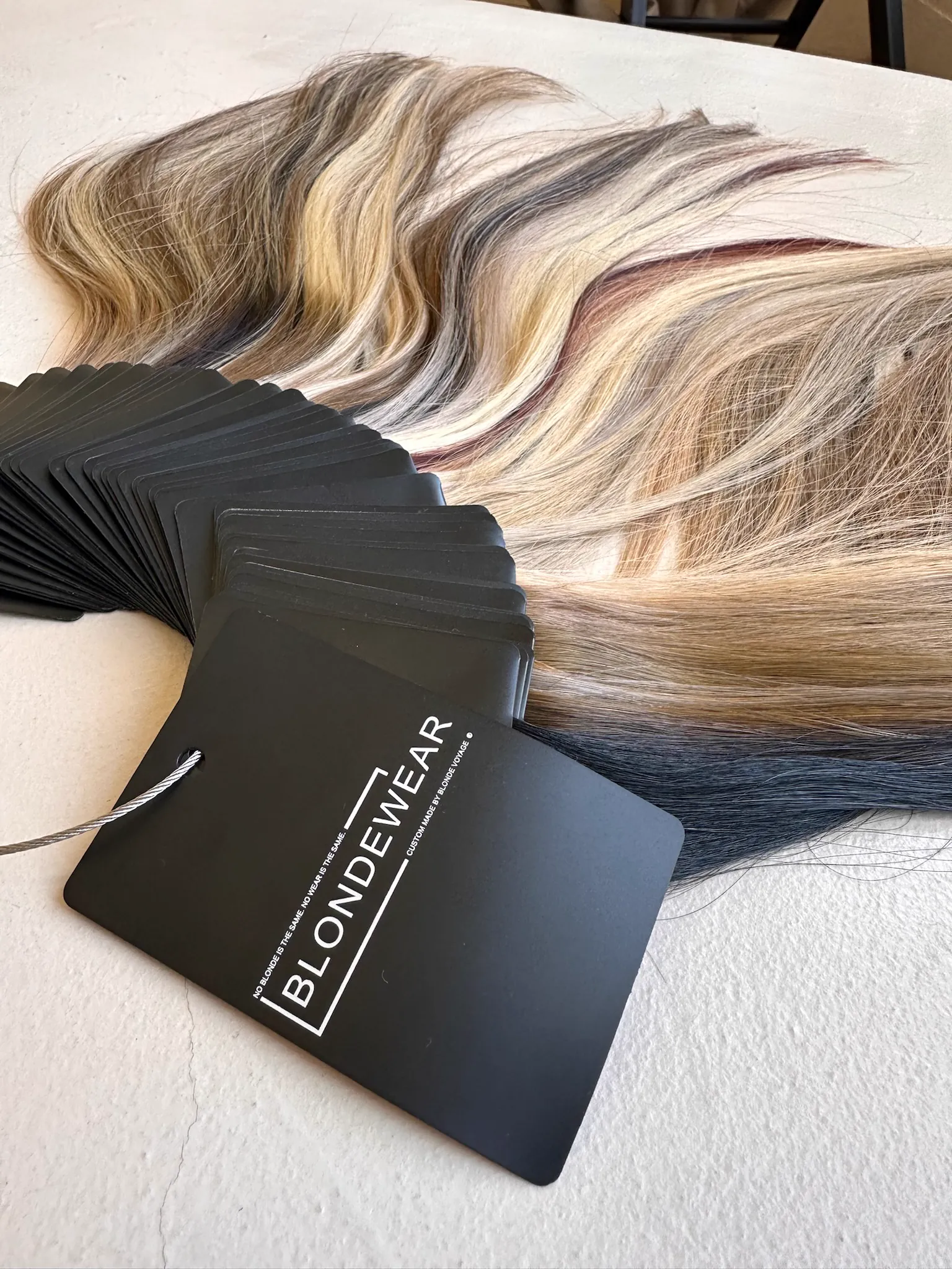 The BlondeWear swatch book, fanned open to show the blonde range