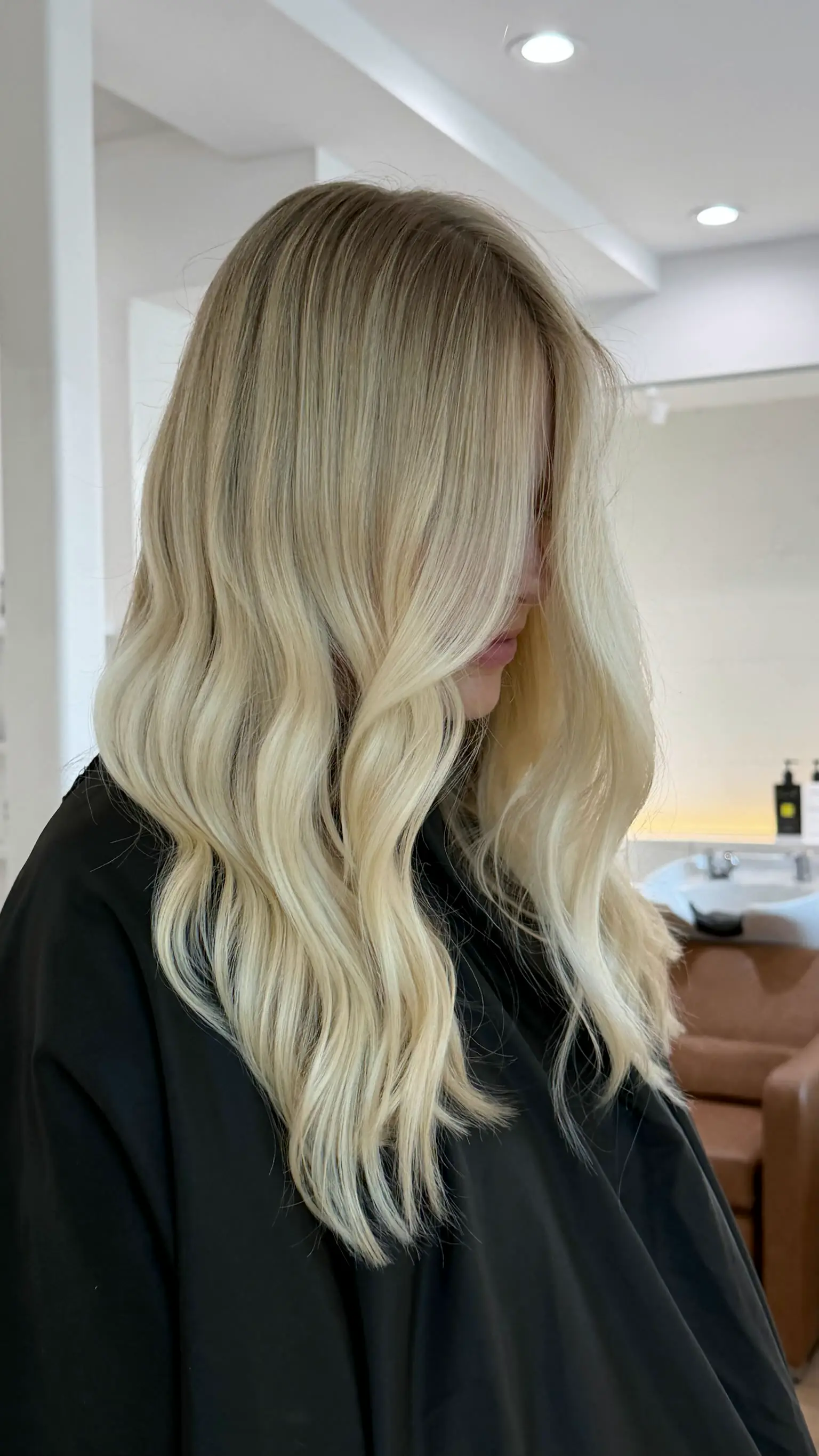 Bright blonde waves in profile at the Temecula backbar
